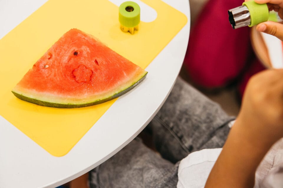 What is Global Developmental Delay 1 A child cutting a watermelon with a cookie cutter