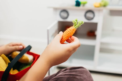 Toilet Training Strategies for Kids with Developmental Support Needs 1 A child holding a carrot