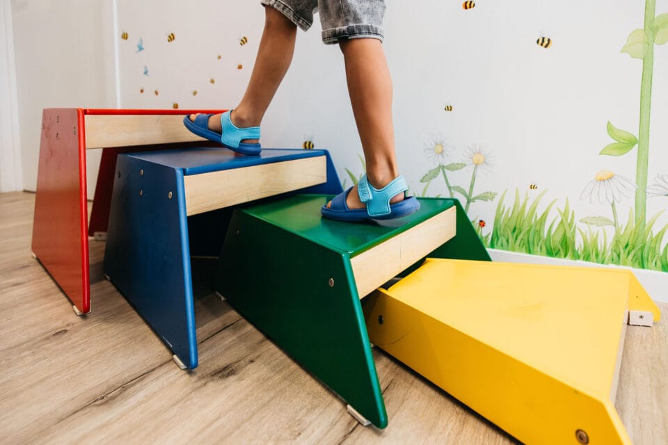 What is Global Developmental Delay 2 A child walking up blocks in occupational therapy
