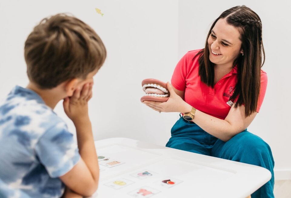 What Is Childhood Apraxia of Speech in Children? 1 Billylids Therapy Speech pathologist showing a mouth model to a child