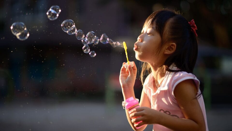 Child blowing bubbles