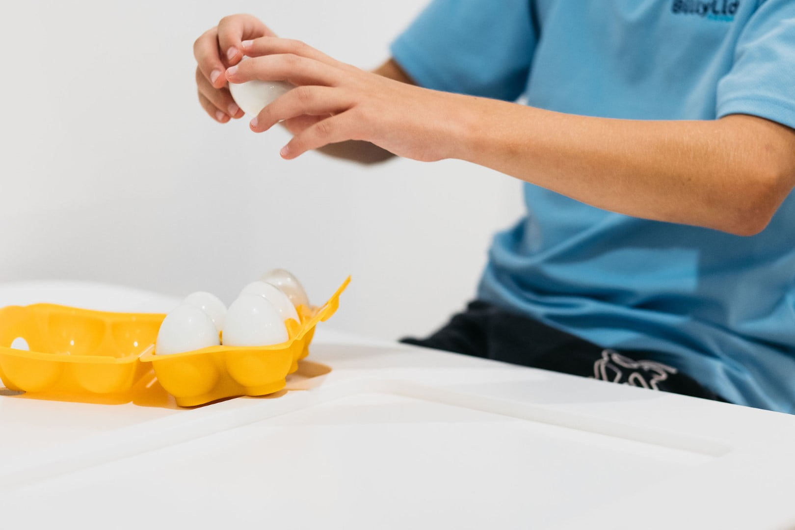 How to Become an Occupational Therapist in Australia 3 Child playing with a carton of eggs