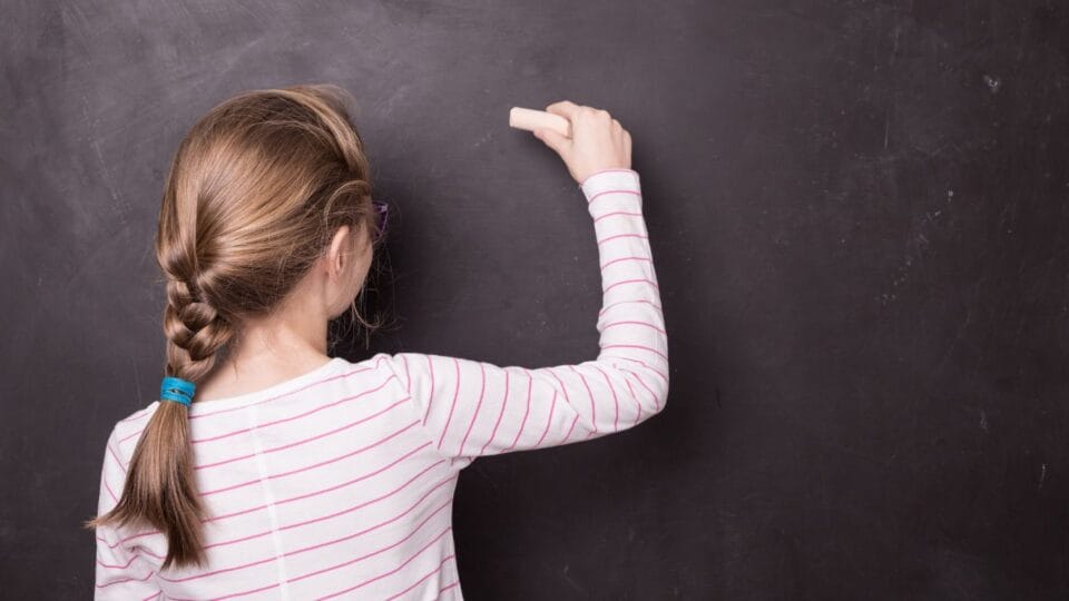 Understanding, Recognising, and Managing Dysgraphia 3 Child writing on a chalk board